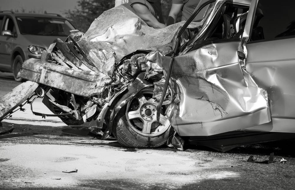 A car with severe front end damage after a collision