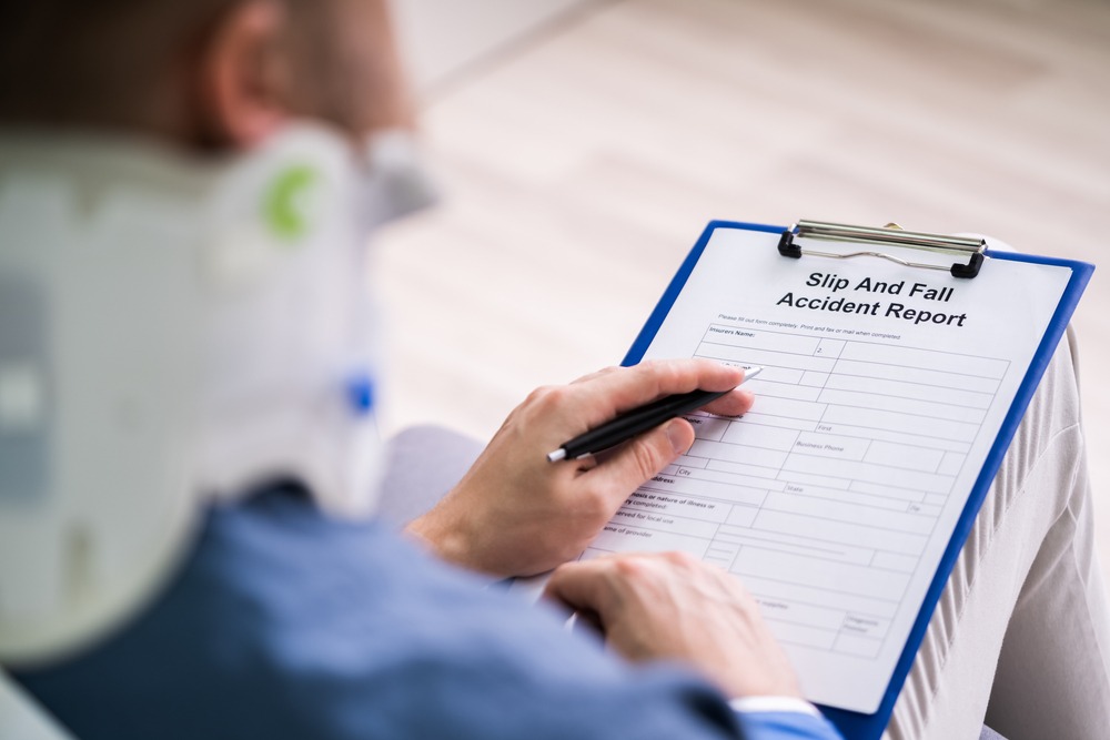 man filling out a slip and fall accident report